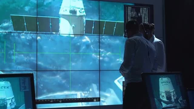 Mission Controllers Watching Ship Undock: Stock Video