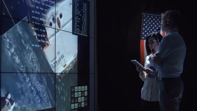 Workers In Space Flight Center: Stock Video