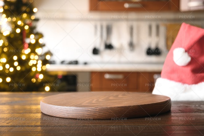 Premium Photo  Wooden tabletop with cutting board and blurred kitchen with  christmas tree background for display or montage your products