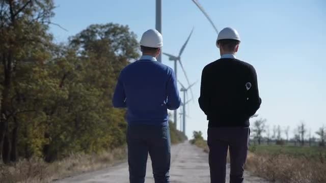 Engineers Walking To Wind Turbines: Stock Video