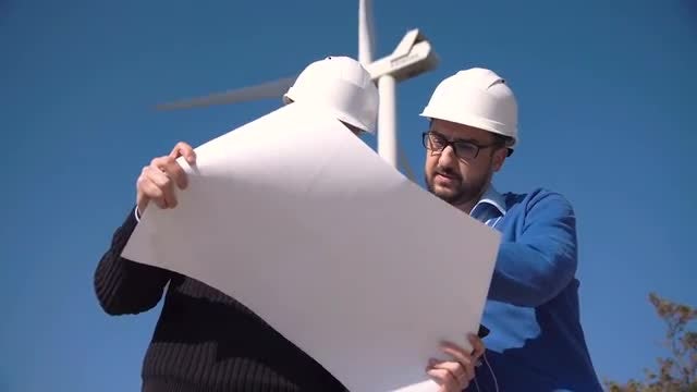 Two Engineers Discussing A Blueprint: Stock Video