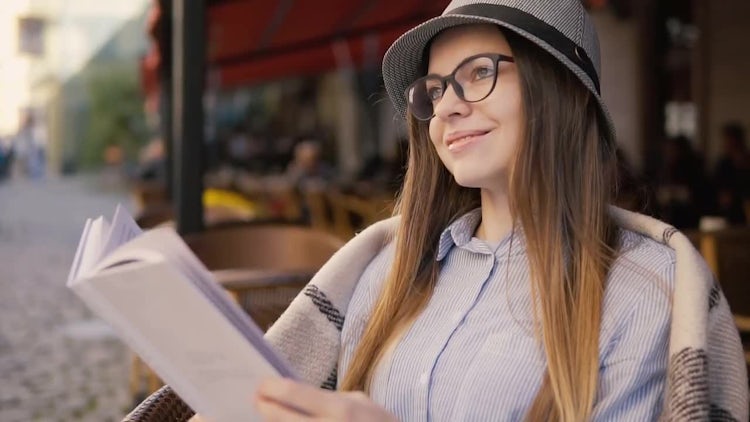 Girl Reading While Drinking Coffee: Stock Video