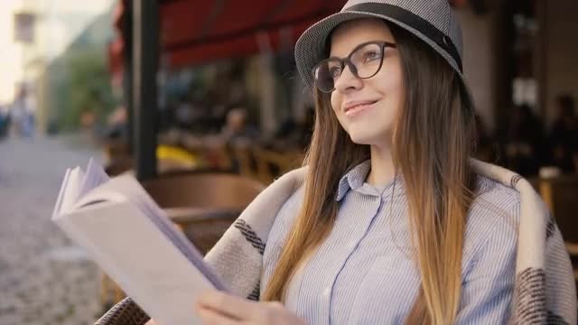 Girl Reading While Drinking Coffee: Stock Video