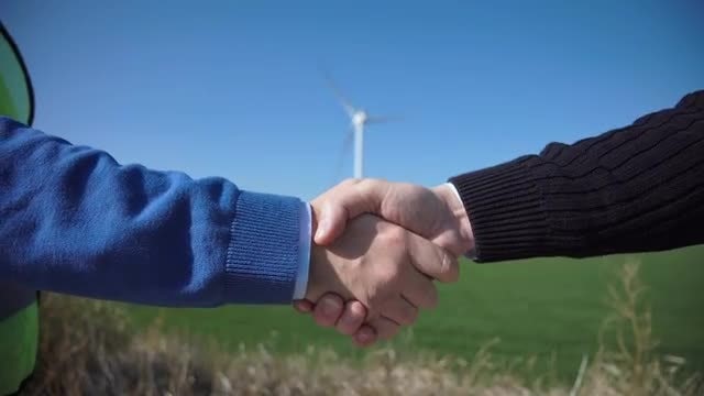 Handshake Over Wind Turbines: Stock Video
