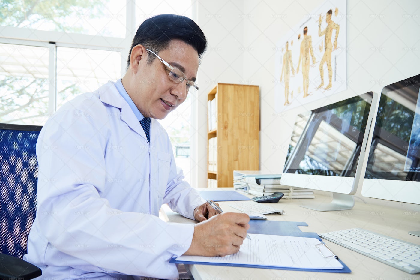 Doctor Doing Paperwork: Stock Photos