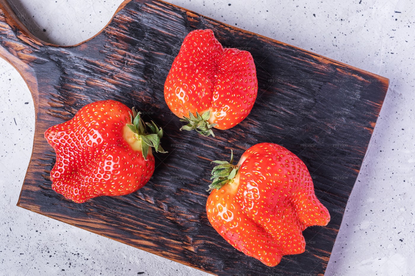 Three Deformed Strawberries: Stock Photos