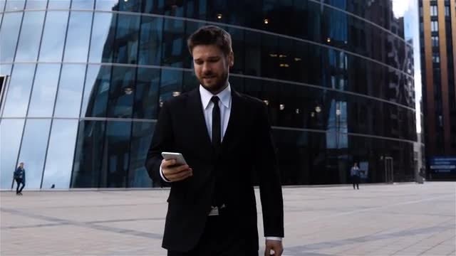 Young Businessman Using Smartphone Outdoors: Stock Video
