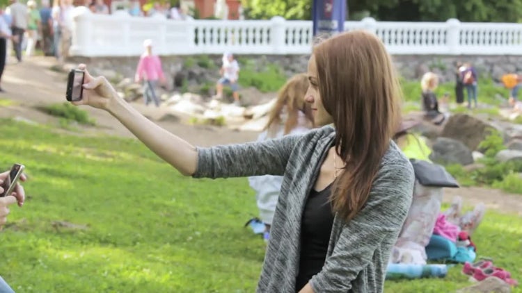 Girl Doing Selfies In Park: Stock Video