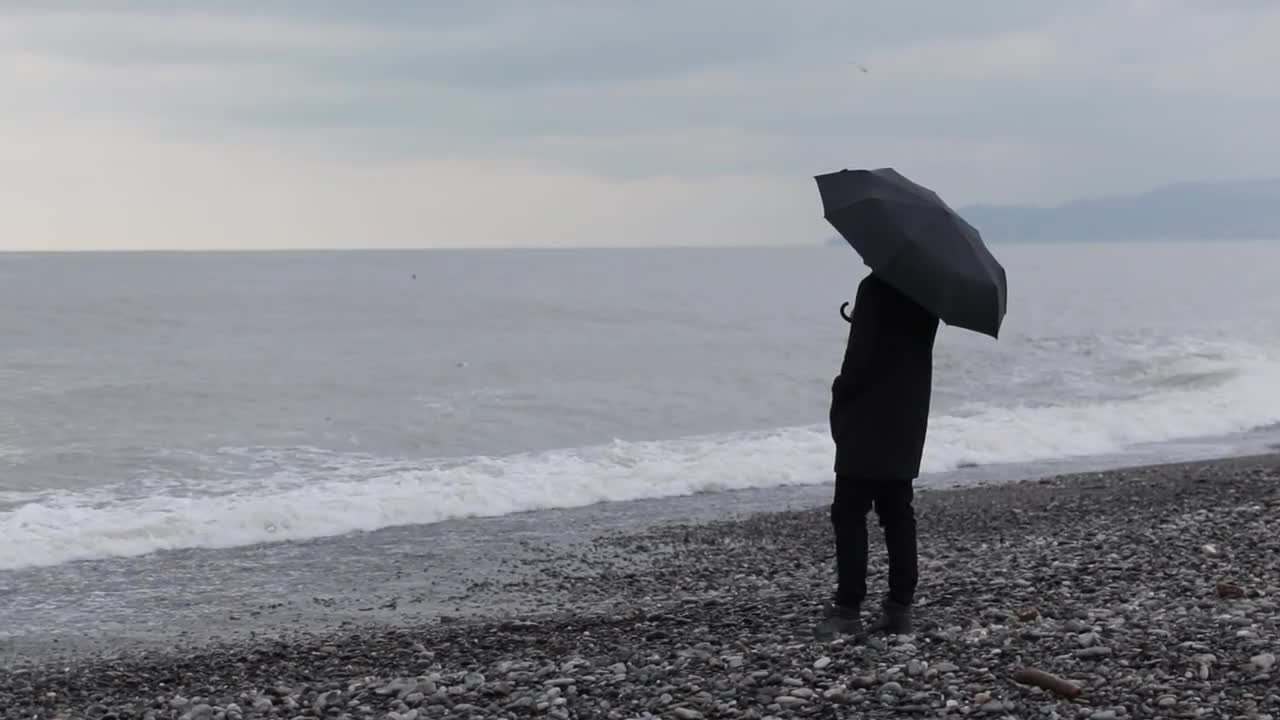 With An Umbrella On The Beach - Stock Video | Motion Array