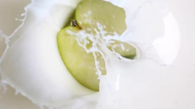 Half Apple Dunked Into Milk : Stock Video