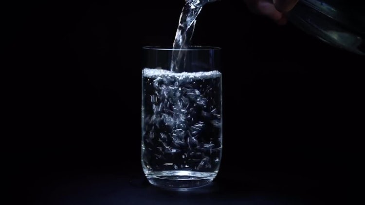 Pouring Water Into Glass Bottle: Stock Video