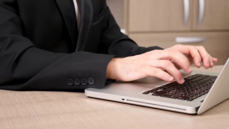 Businessman Typing On A Laptop: Stock Video
