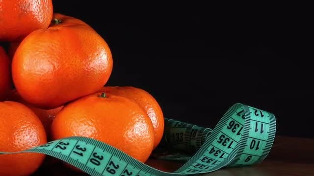 Mandarin Oranges With Measurement Tape: Stock Video