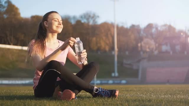 Girl Drinking Water In Stadium: Stock Video