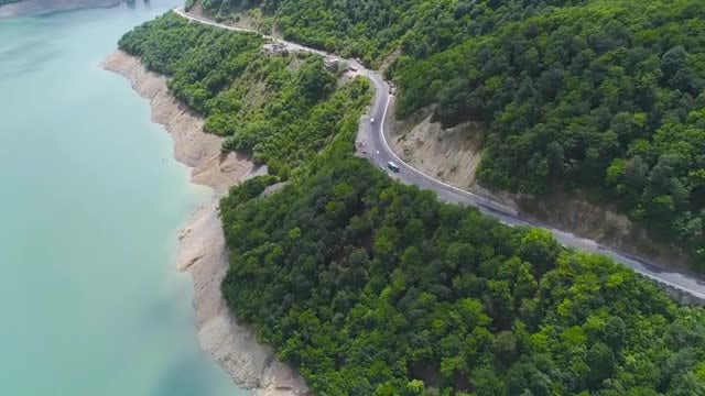 Aerial View of Cars Driving By A Lake: Stock Video