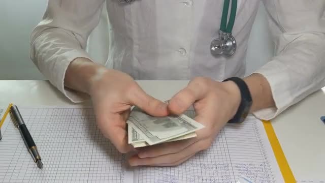 Doctor Counting Money In Hospital: Stock Video