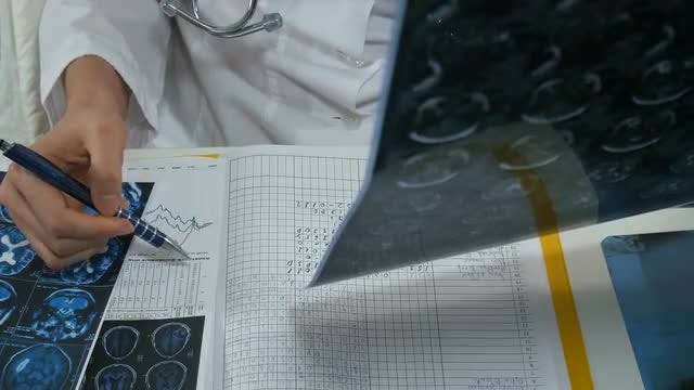 Doctor Filling Up Medical Journal: Stock Video