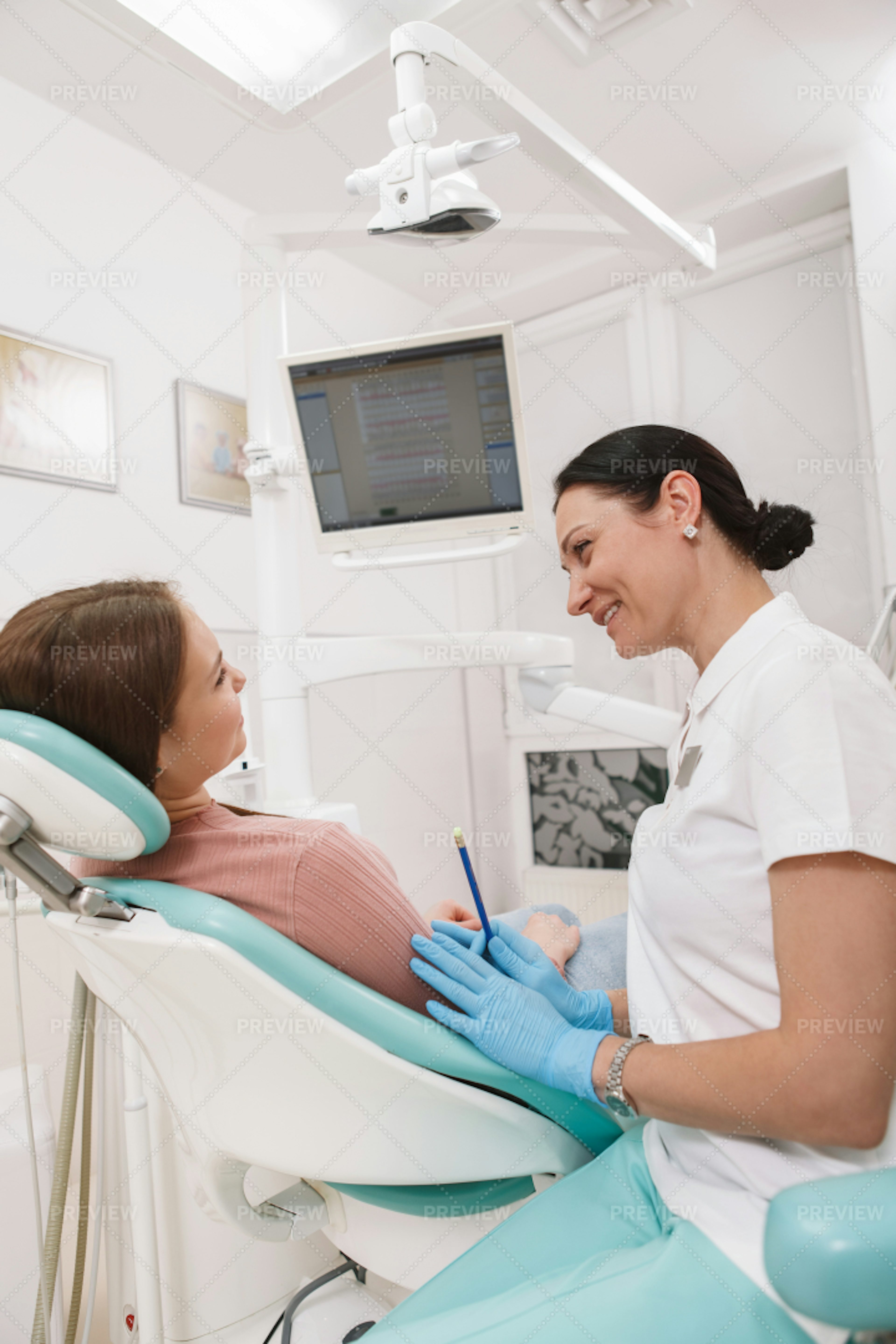 Dentist Talking To Her Patient - Stock Photos 