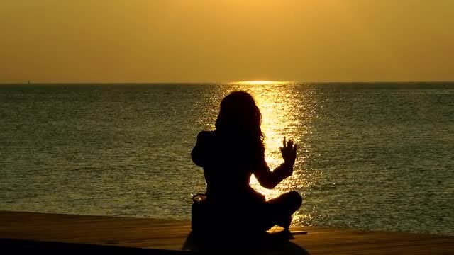 Woman Sitting On The Beach Watching the Sunset: Stock Video