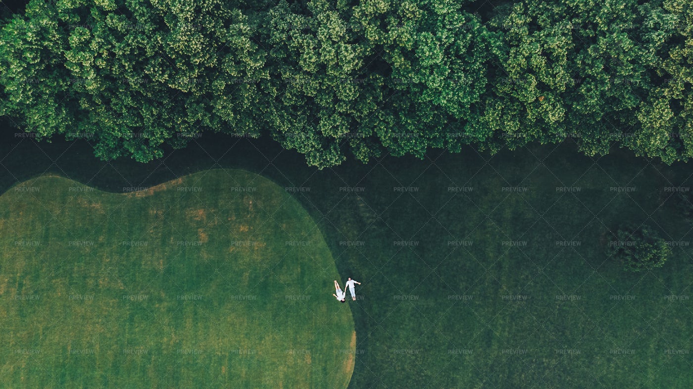 Couple Is Lying On A Golf Course: Stock Photos