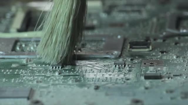 Dusting Off Laptop Motherboard: Stock Video