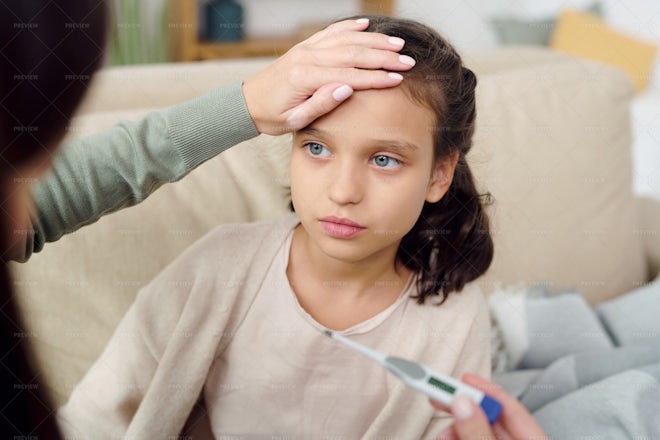 Female Hand Touching Daughter Forehead - Stock Photos | Motion Array