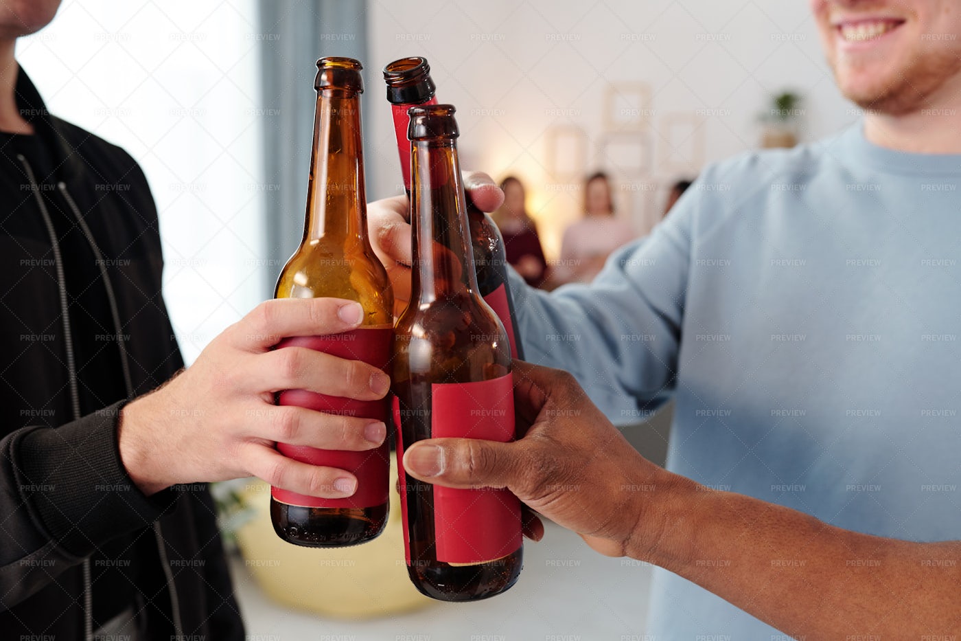 Hands Of Men Clinking Beer Bottles: Stock Photos