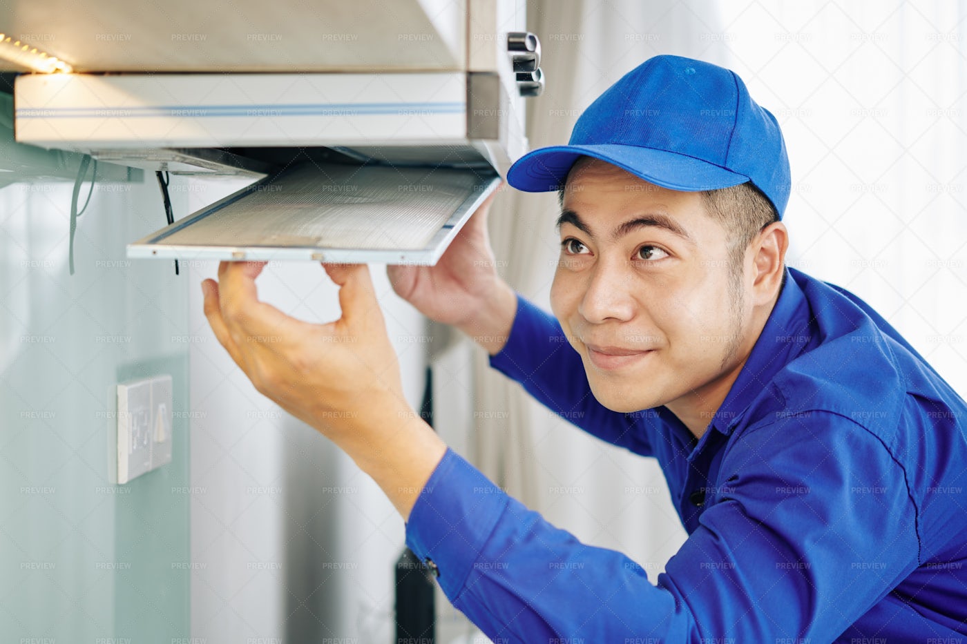 Worker Installing Cooker Hood: Stock Photos