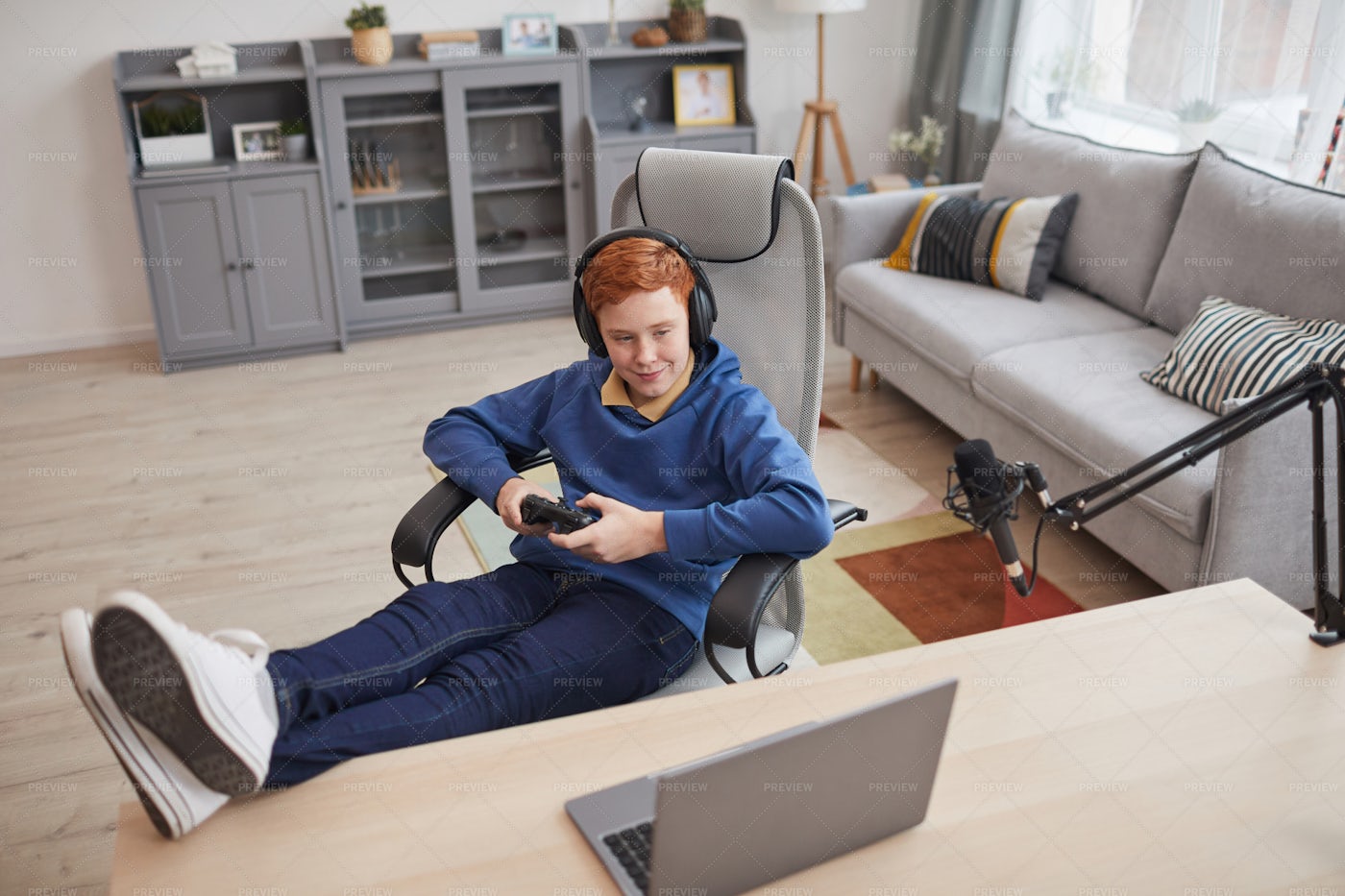 Relaxed Boy Playing Video Games: Stock Photos