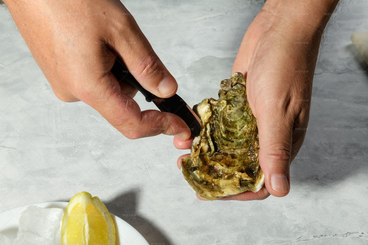 Hands Opening An Oyster: Stock Photos