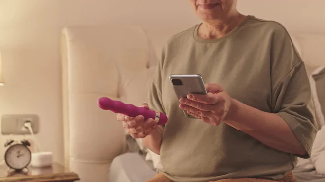 Senior Woman Holding Vibrator And Using Smartphone In Bed by SeventyFour - Stock Video | Motion Array Senior Woman Holding Vibrator And Using Smartphone In Bed by SeventyFour - Stock Video | Motion Array